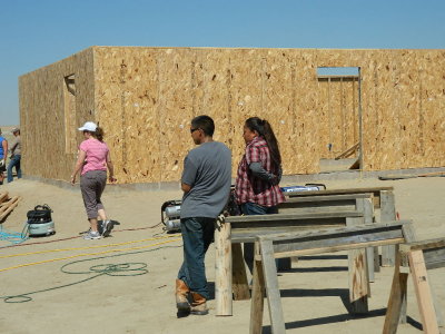 Happy Family observing their new home being built
