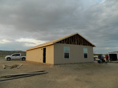 Roof and siding on, windows and one door set