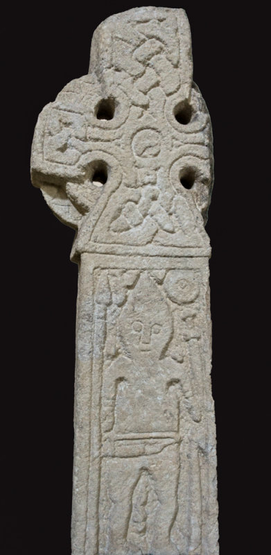 Middleton Viking Age warrior on a stone cross, with seax, spear, sword and axe.