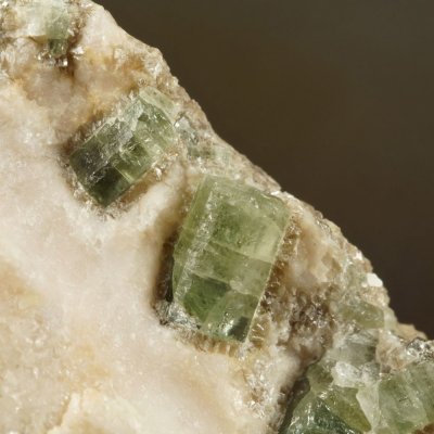 Green apatite prisms to 1 cm in calcite, 65 mm specimen. Carrock Mine, Carrock Fell.