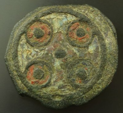 Anglo Saxon enamelled disc brooch in champlevé, 9th Century, with a green cross defined by the four red circles. Norfolk.