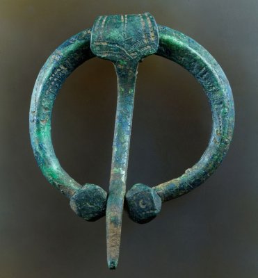 Viking age pennanular brooch, 42 mm wide, with polyhedral terminals and both linear and stamped decoration, Baltic. 