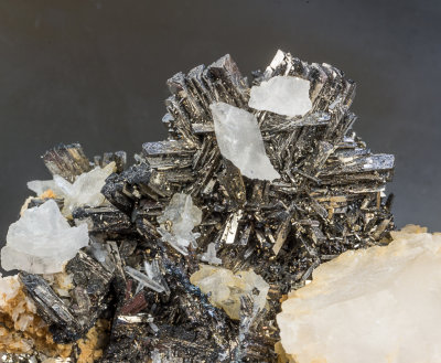 Arsenopyrite trilling twin (18 mm) with calcite on 5 cm specimen, Huanzala, Huanaco Provine, Peru.