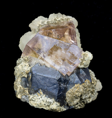 Fluorite penetration twin (35 mm on edge) with galena (3 cm crystal) and calcite, 8 cm specimen, Boltsburn Mine, Co Durham.