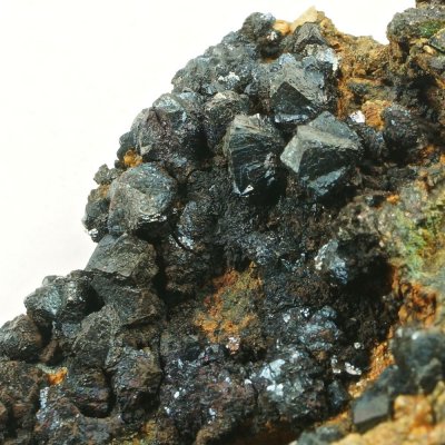 Bornite penetration twins to 6 mm on 8 cm matrix, Carn Brea Mine, Illogan, Cornwall.