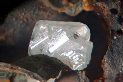 Phosgenite crystal, 2 mm on 15 mm matrix from Penpol Smelter, Penpol, Carnmenellis, Cornwall.