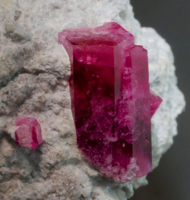 Red beryl, 12 mm long, transparent, on rhyolite, Violet Claims, Wah Wah Mountains, Beaver County, Utah.