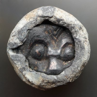 Lead weight, 29 mm diameter, with inset fragment of insular metalwork.