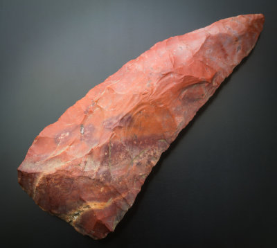 Poverty Point, curved red chert knife blade, 65 mm. Morehouse Parish, Louisiana, USA. Found by Richard Hughes.