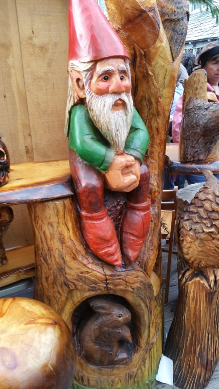 A little gnome and tiny bunny carved in wood.