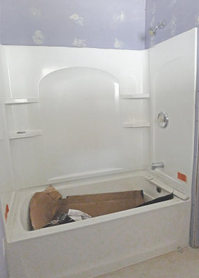 THE TEAM INSTALLED A NEW BATHTUB AND SURROUND