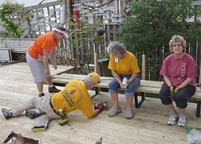 SITTING DOWN ON THE JOB  -  HOLDING DOWN THE BENCH SEAT BOARDS TO MAKE IT EASIER TO FASTEN THEM TO THE DECK