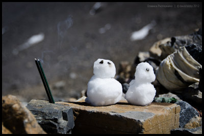 Snowmen and an offering at the pass