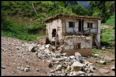 Abandoned house at the toe of the slide