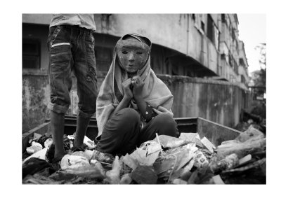 Girl with mask in dumpster, Mumbai