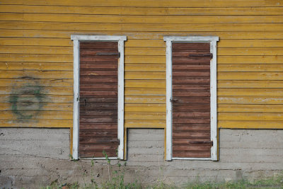 Two doors beside extinct dartboard