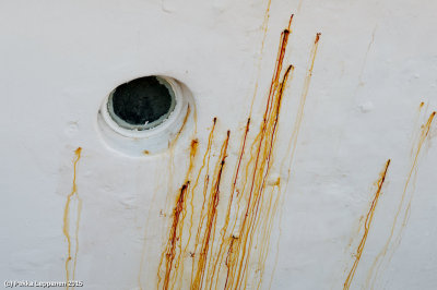 Ship porthole with rust
