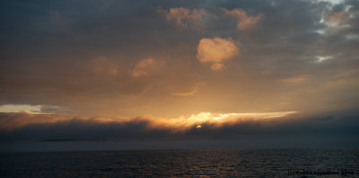 Sun setting over sea fog II