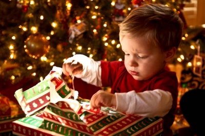 Peyton opening a present at an early Christmas.