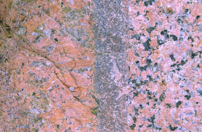 Pegmatite dike (left) intrudes granite host rock, creating a fine grained chill zone (center),  Llano,TX