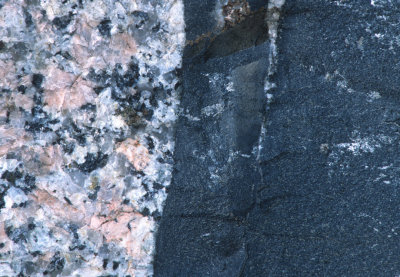 Basalt (black rock) intrudes into granite.  Notice how the basalt crystals get larger away from the contact.