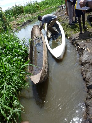 Typical dugout wooden canoe next to a fiberglass canoe donated by an NGO.