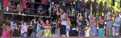 Michael Franti and lots of children onstage