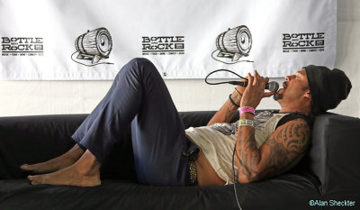 Michael Franti in the media tent, taking questions therapy-style, from the couch