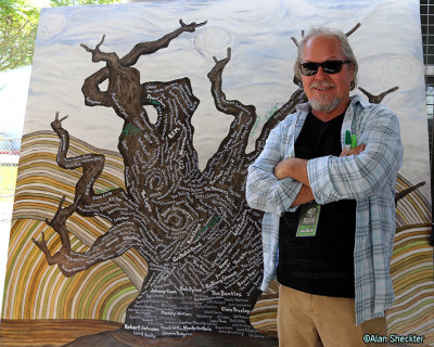 Artist standing with his music tree piece