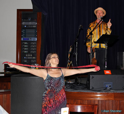 Leah of KZFR makes a final appeal for raffle tickets, while Joe Craven picthes from the stage