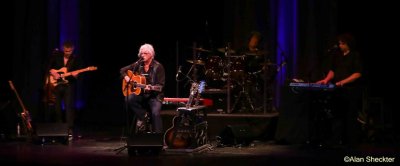 Arlo Guthrie and the band: Abe Guthrie on keyboards, Bobby Sweet on guitar, and drummer Terry A La Berry