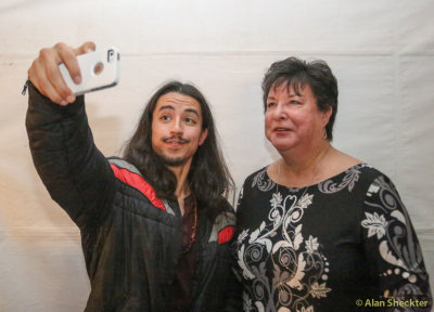 Alex creating a selfie with a fan