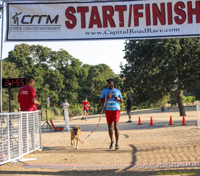 Norman and his dog , Peyton, of Roseville - first person/dog team across the finish line