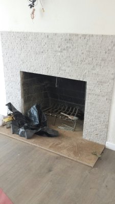 38. New fireplace facing, tiny grey cement-like tiles, greyish wood laminiate