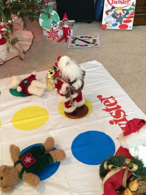 santa jr., our elf, playing twister with his friends
