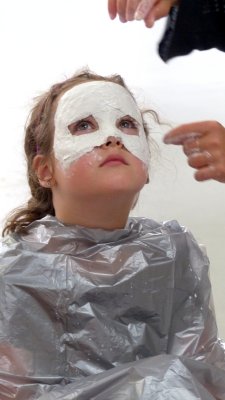 The little girl in the mask-making workshop