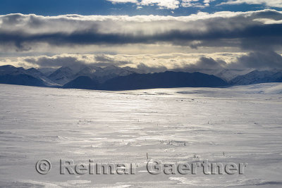 Clouds over the snow covered Brooks Range mountains Alaska from the Dalton Highway