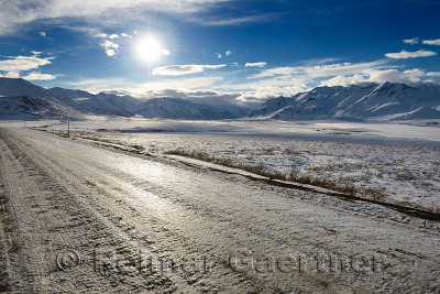 Ice covered dirt road Dalton Highway in the Brooks Range mountains Alaska
