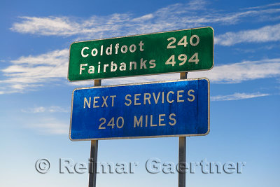 Signs in Deadhorse Alaska for Coldfoot and Fairbanks indicating one service station on the Dalton Highway