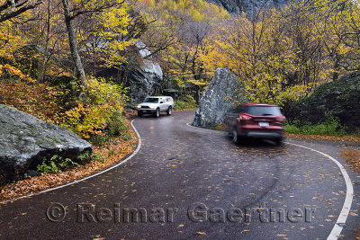 Cars passing on Highway 108 pass through boulders at Smugglers Notch State Park Vermont