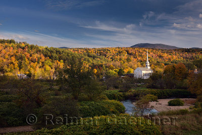 Stowe Community Church and Brush Hill with Fall colors in evening sun at Stowe Vermont