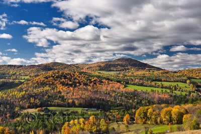 Barnet Center valley with hills in Fall colors Vermont with clouds