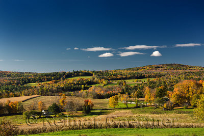 View of colorful Fall countryside farms and Jennison Mountain from Peacham Vermont