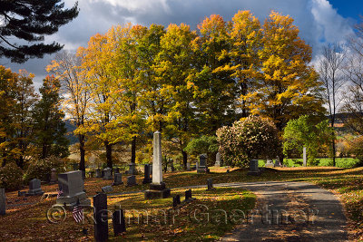Green and orange Maple trees at Peacham Corner Cemetery Vermont in the Fall