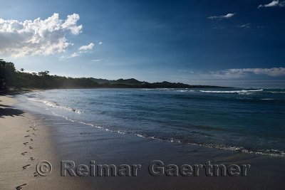 Emerging footprints on the sand on the beach of Maimon Bay Dominican Republic in the evening