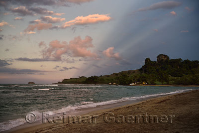 Pink light and clouds at sunset with waves on the beach of Maimon Bay Dominican Republic