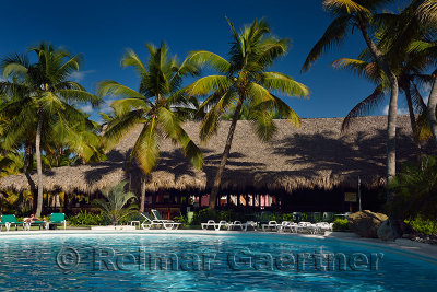 Pool and bar with coconut palm trees in Puerto Plata Dominican Republic