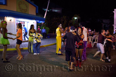 Guests and staff dancing to merengue music at a Resort outdoor street party Dominican Republic
