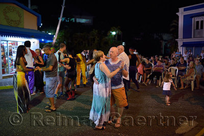 Couples dancing to merengue music at a Resort outdoor street party Dominican Republic