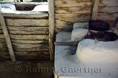 Wood burning kitchen stove and outdoor sink in wood house in rural Dominican Republic